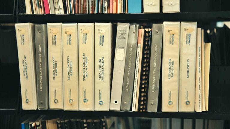 Books on energy systems and maintenance on shelf.