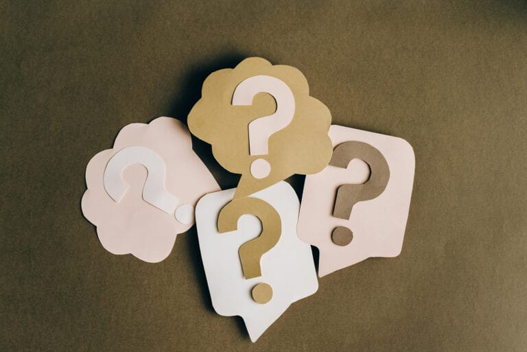 Colorful paper cutouts with question marks