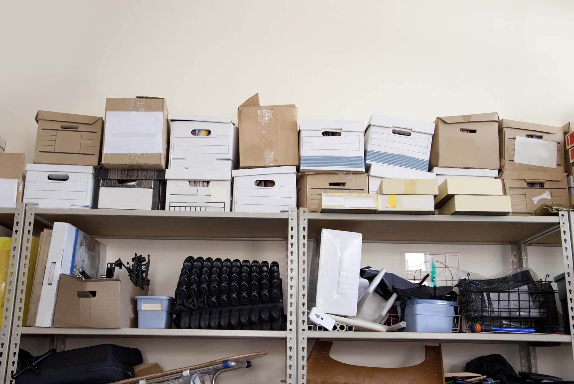 Storage shelves stacked with boxes and miscellaneous items.